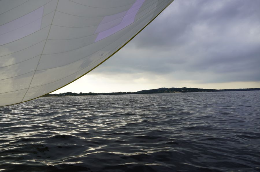 Sailing under gray skies on dark water